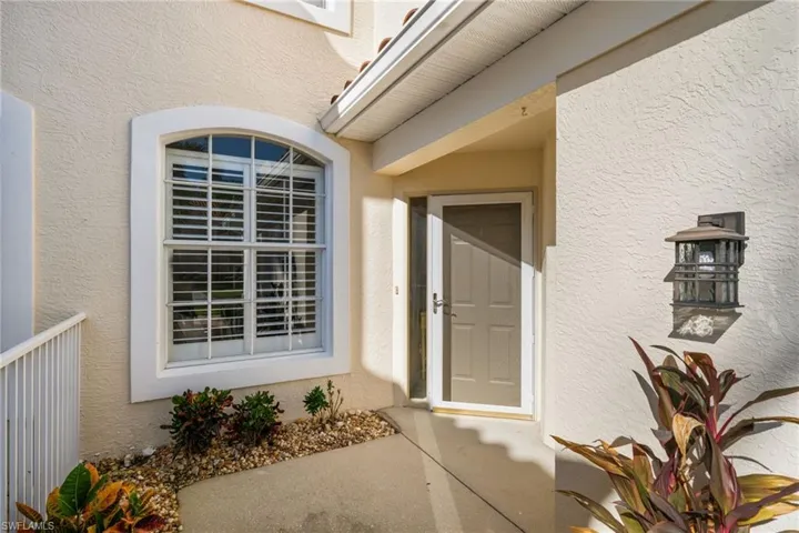 View of exterior entry featuring a screen door.
