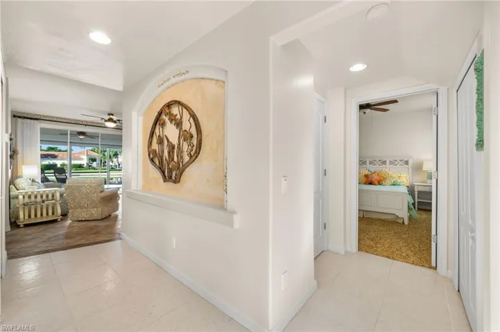 Hallway from entry. 2nd bedroom to the right. Main living area with lakeviews to the left.