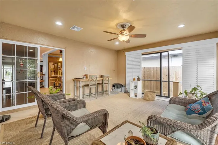 Living room featuring ceiling fan, plenty of natural light, and light tile patterned flooring