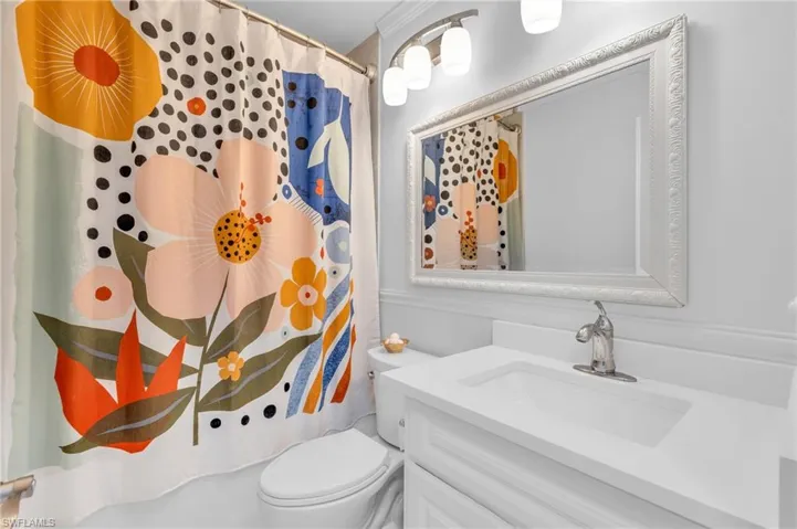 Bathroom with vanity, toilet, and walk in shower