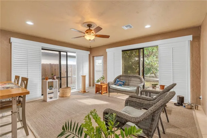 Sunroom / solarium featuring ceiling fan