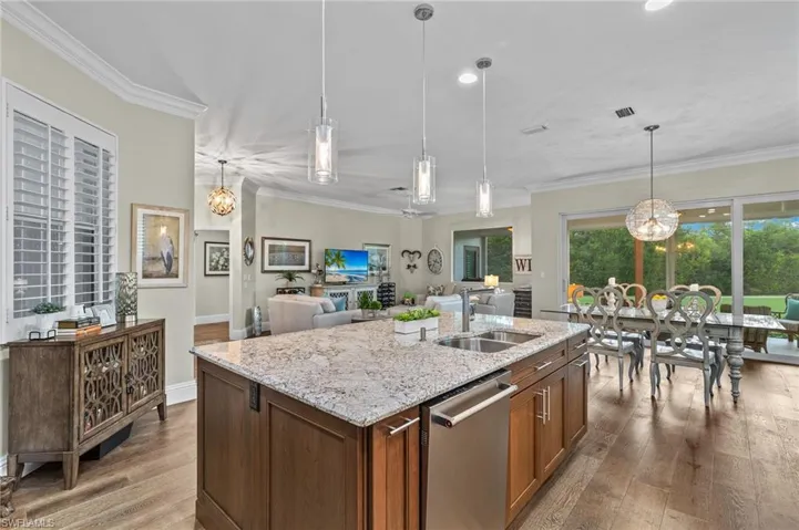 Kitchen with light hardwood / wood-style flooring, a healthy amount of sunlight, dishwasher, and sink