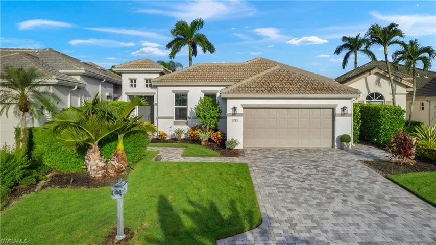 Mediterranean / spanish-style house featuring a garage and a front yard