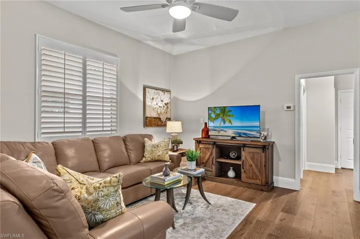 Living room featuring hardwood / wood-style floors and ceiling fan