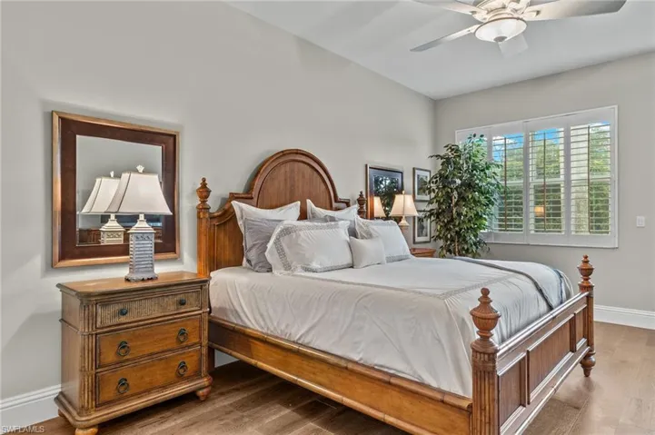 Bedroom with ceiling fan and dark hardwood / wood-style floors