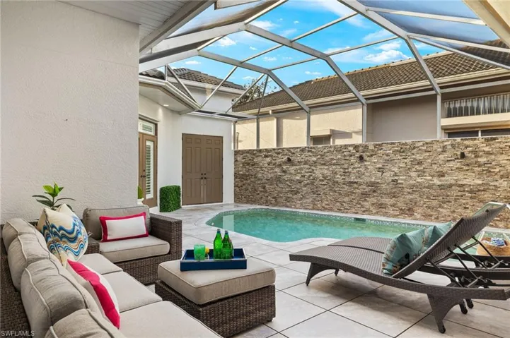 View of pool with an outdoor living space, a lanai, and a patio area
