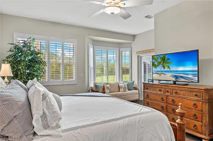 Bedroom featuring multiple windows and ceiling fan