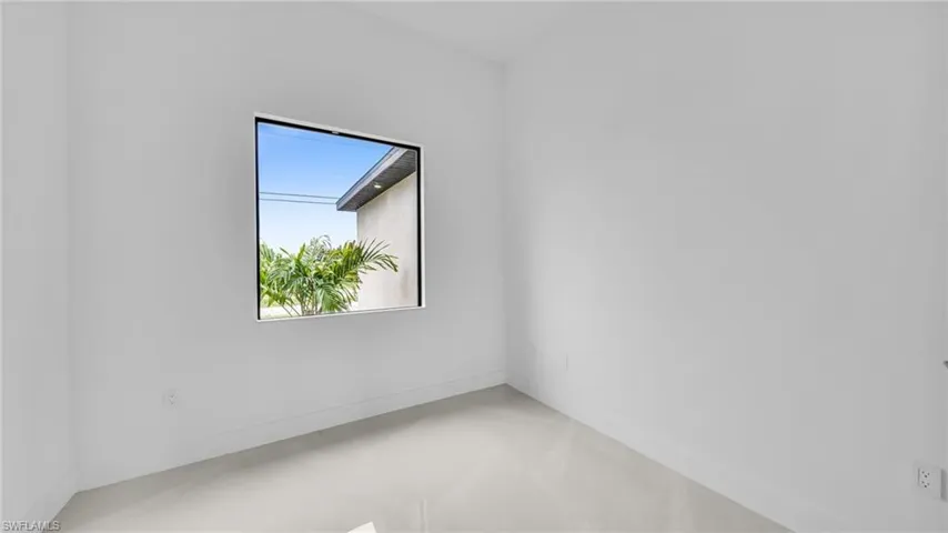 Unfurnished room with baseboards and concrete flooring