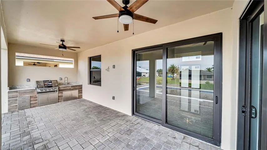 View of patio featuring an outdoor kitchen and a ceiling fan