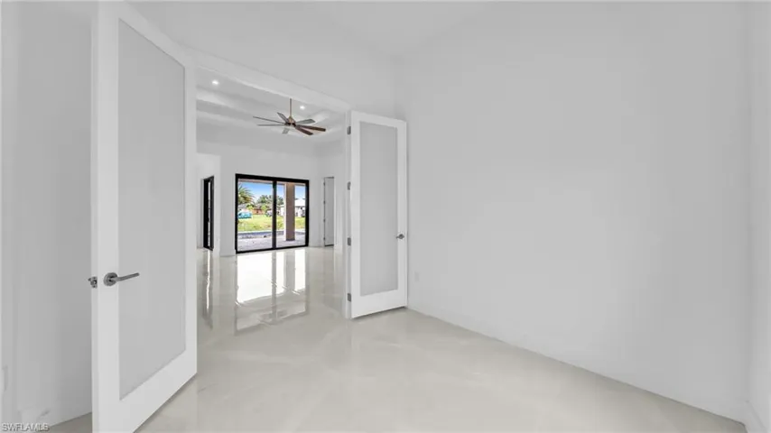 Spare room featuring french doors and ceiling fan