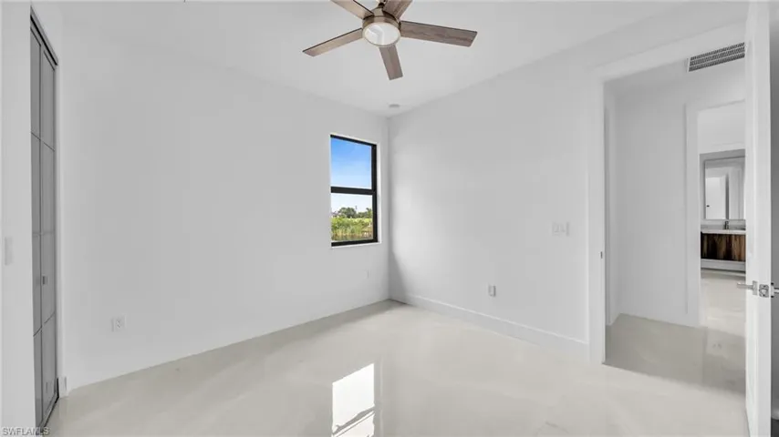 Unfurnished bedroom featuring a ceiling fan, concrete floors, and a closet