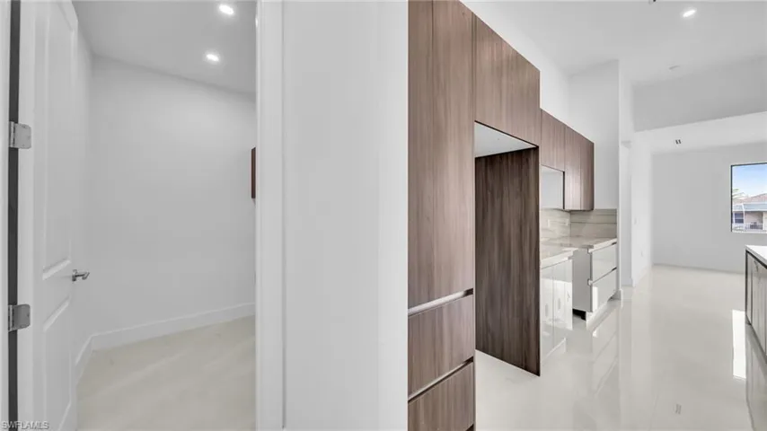 Corridor featuring recessed lighting and baseboards