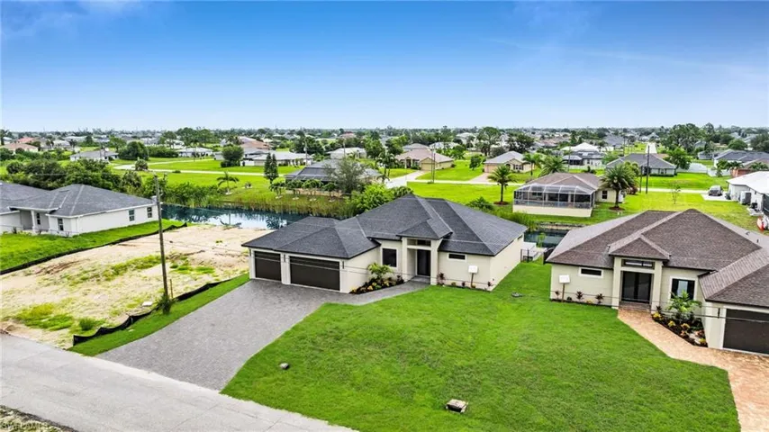 Aerial perspective of suburban area with a nearby body of water