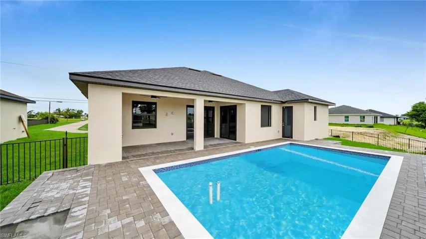 Back of property with a ceiling fan, stucco siding, a patio area, and a shingled roof