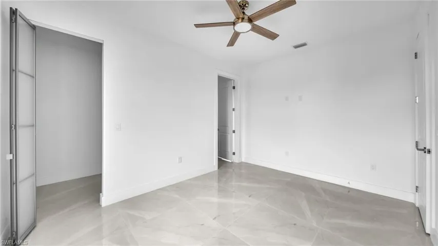 Unfurnished bedroom with a ceiling fan and baseboards
