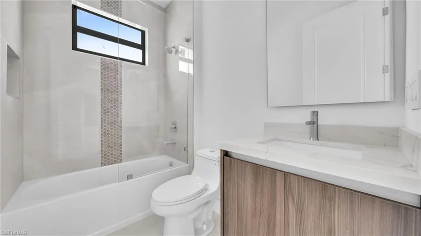 Bathroom with vanity and bathing tub / shower combination