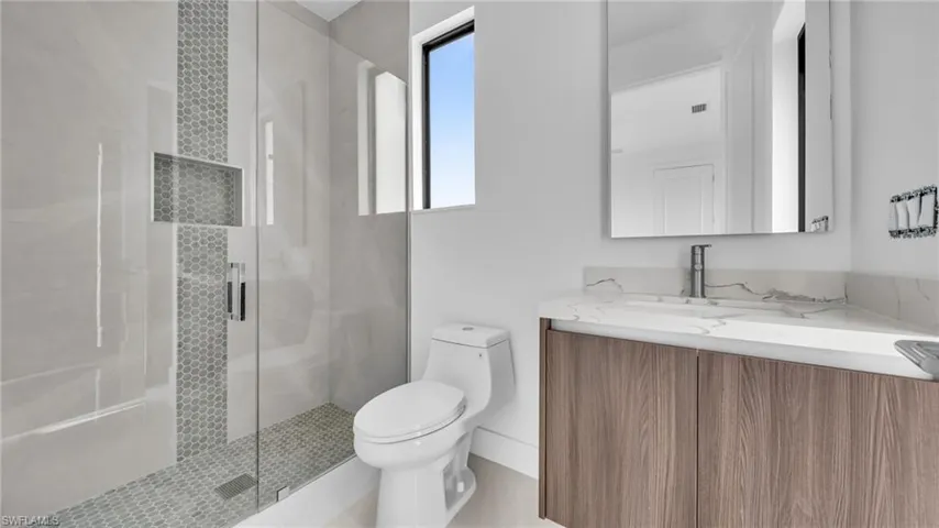 Bathroom with vanity and a stall shower