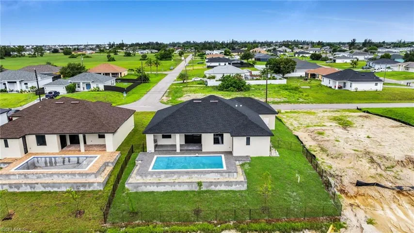 Aerial view of residential area featuring a pool