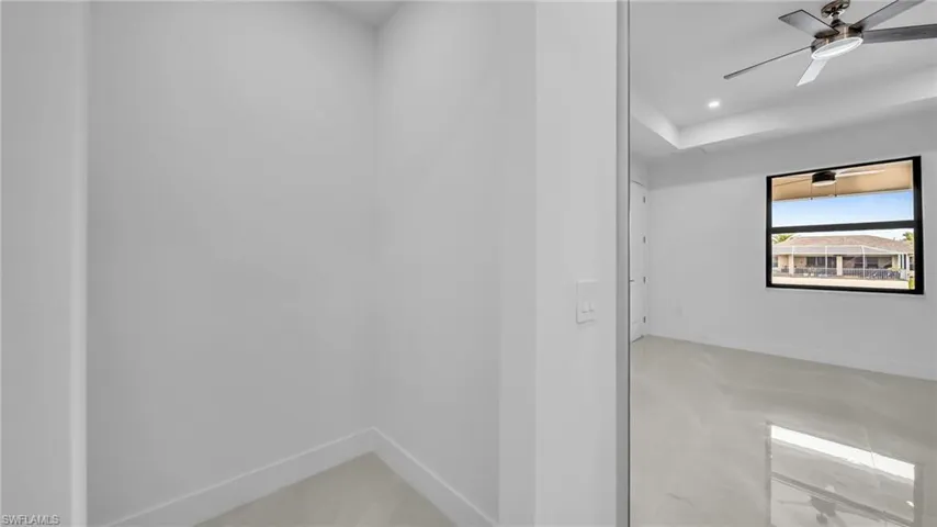 Empty room with ceiling fan and recessed lighting