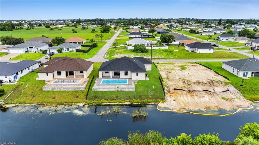 Aerial view of residential area featuring a large body of water