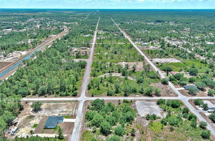 Aerial overview of property's location featuring a tree filled landscape
