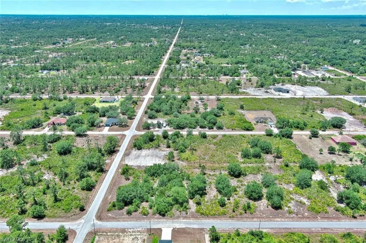 Aerial view of property's location featuring a forest