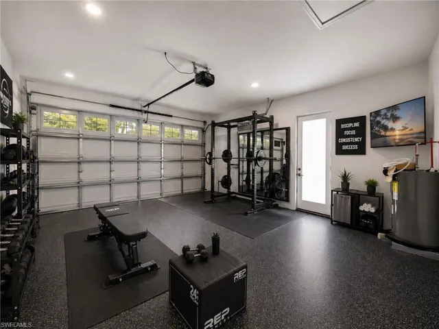 virtually staged:Garage space featuring a rubberized flooring system and recessed lighting