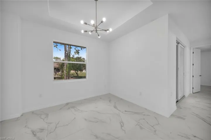 Bright interior space featuring large format marble-look tile flooring