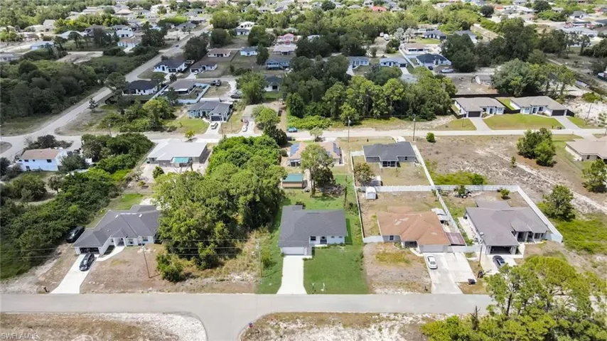 Aerial representation of a residential neighborhood featuring single-story homes, paved streets, and a mix of developed and undeveloped lots
