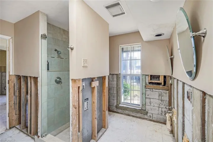 Full bath featuring visible vents and a tile shower