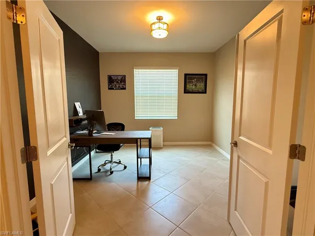 Office area featuring baseboards and light tile patterned floors