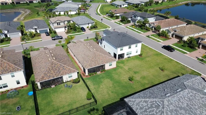 Aerial view of residential area featuring a nearby body of water