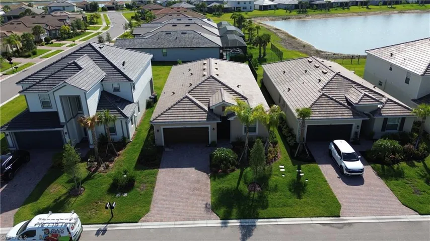 Aerial perspective of suburban area featuring a large body of water
