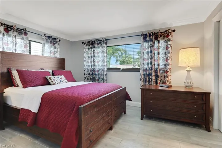 Bedroom with crown molding and light wood-type flooring