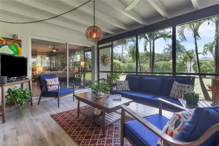 Sunroom featuring outdoor lounge area, beamed ceiling, and healthy amount of natural light