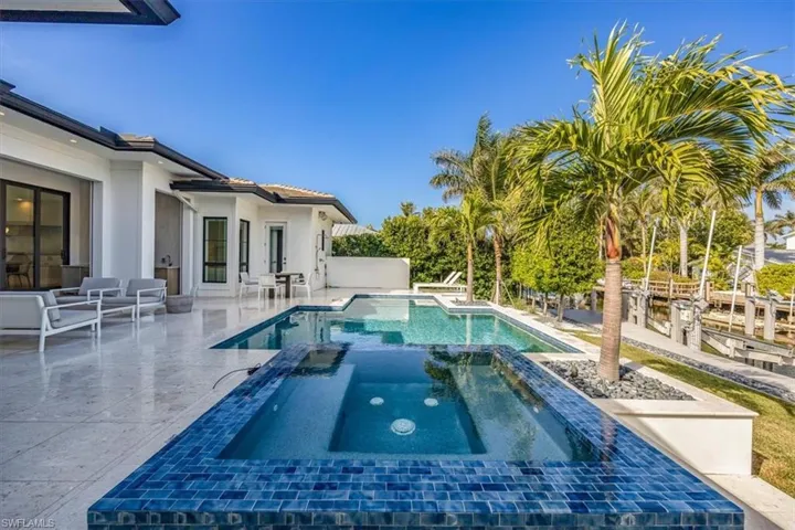 View of pool with an in ground hot tub and a patio area