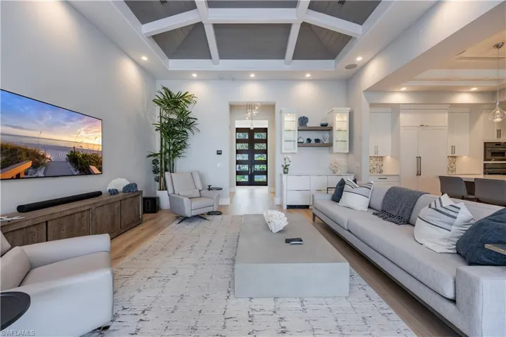 Living room featuring hardwood / wood-style flooring and a towering ceiling