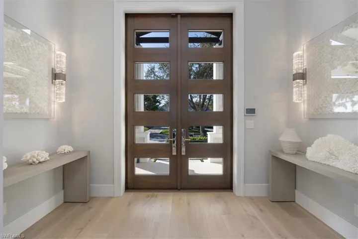 Entrance foyer with light hardwood / wood-style flooring and french doors