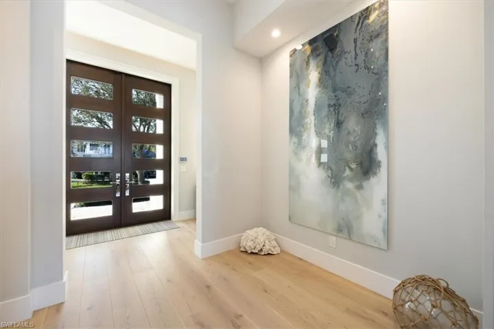 Foyer featuring light wood-type flooring and french doors