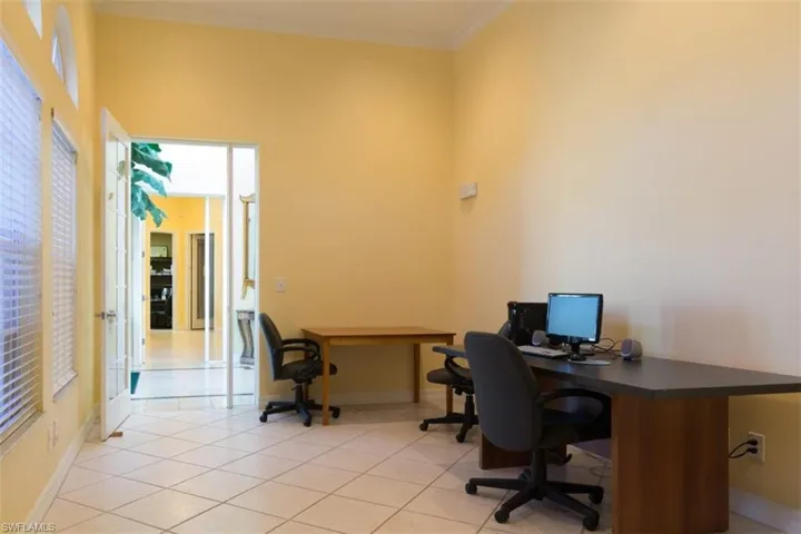 Home office featuring ornamental molding and light tile patterned flooring