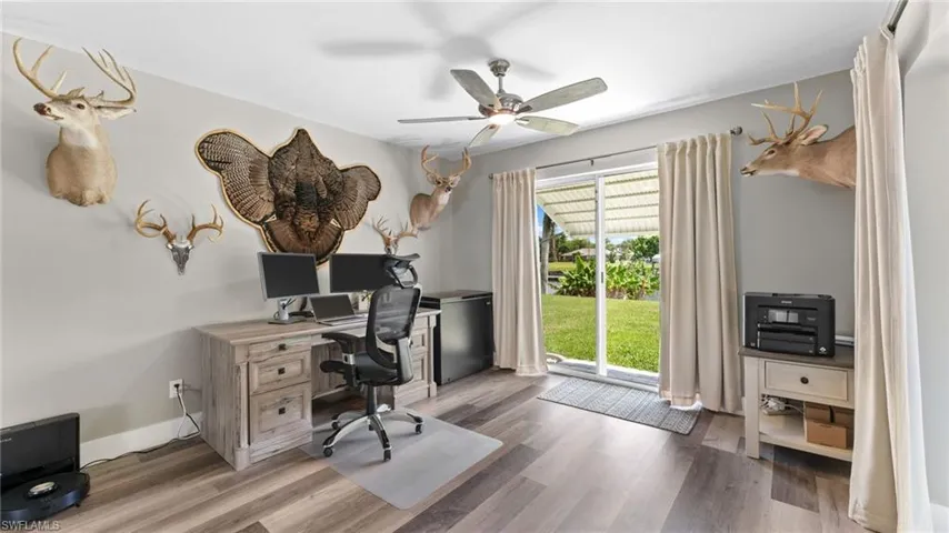 Home office with hardwood / wood-style floors, a wealth of natural light, and ceiling fan
