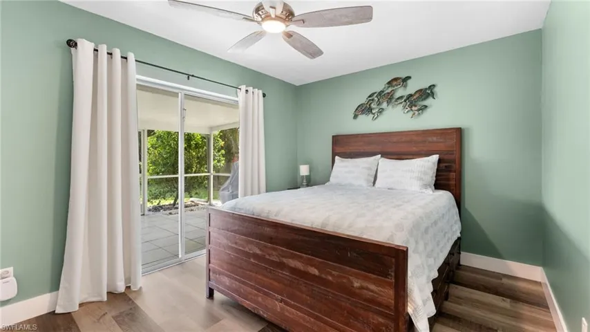 Bedroom featuring light wood-type flooring, access to outside, and ceiling fan