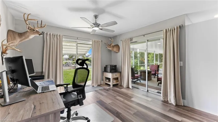 Office with hardwood / wood-style flooring, plenty of natural light, and ceiling fan