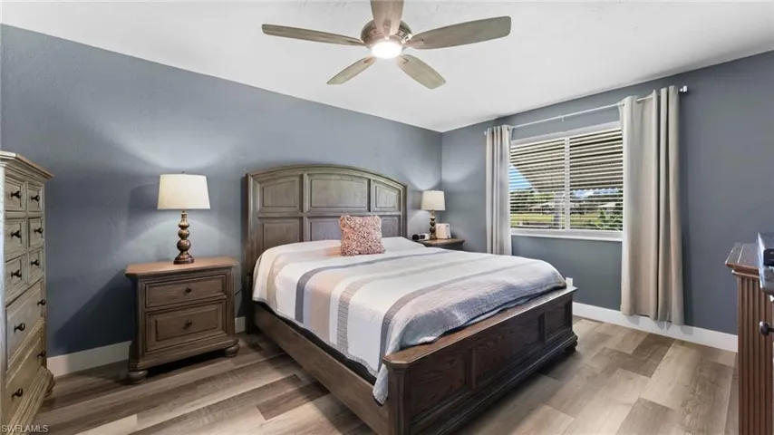 Bedroom featuring ceiling fan and light wood-type flooring