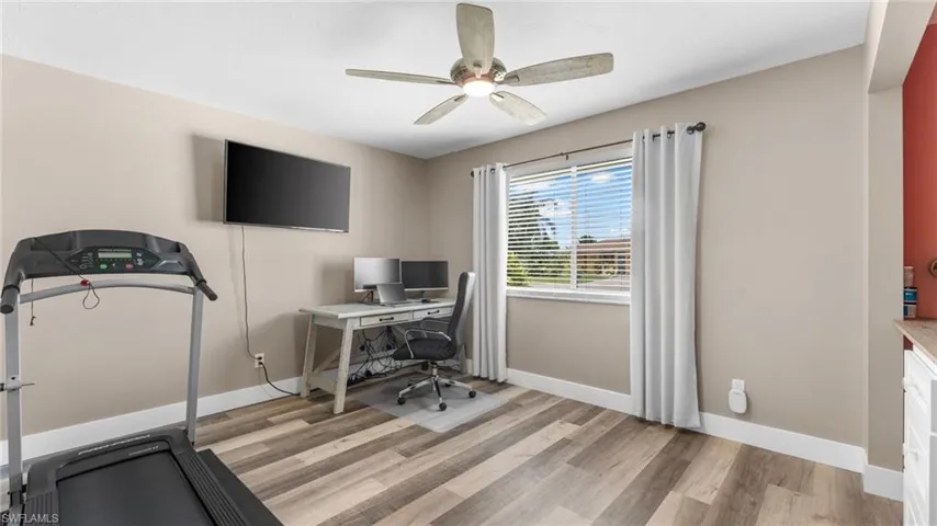 Home office featuring light wood-type flooring and ceiling fan