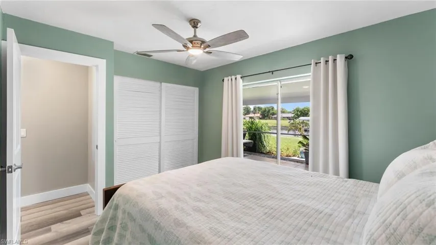 Bedroom featuring ceiling fan, a closet, light hardwood / wood-style floors, and access to outside