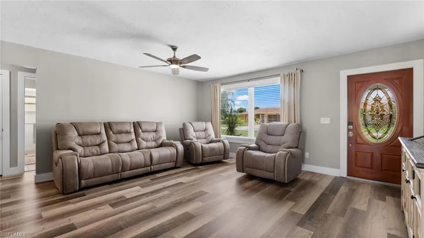 Living room featuring ceiling fan and wood-type flooring