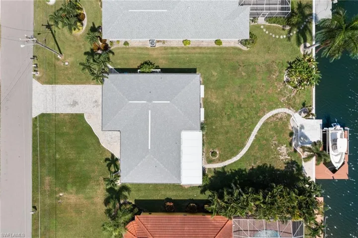 Birds eye view of property with a water view