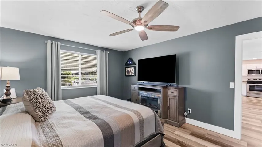 Bedroom featuring ceiling fan and light wood-type flooring