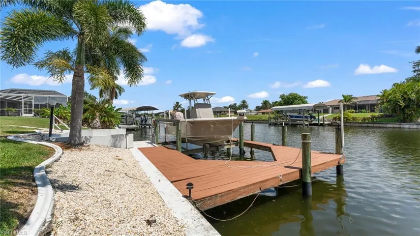 Dock area featuring glass enclosure and a water view